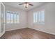 Empty bedroom with hardwood floors, a ceiling fan, lots of natural light, and shutter blinds on the windows at 10610 Reunion Pkwy, Commerce City, CO 80022