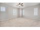 Spacious bedroom with multiple windows providing ample natural light and ceiling fan at 10610 Reunion Pkwy, Commerce City, CO 80022