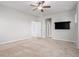 Empty bedroom featuring wall-mounted TV and neutral carpet at 10610 Reunion Pkwy, Commerce City, CO 80022