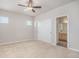 Bedroom features carpet, neutral walls, ceiling fan, and closet with sliding doors at 10610 Reunion Pkwy, Commerce City, CO 80022