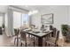 Dining area with stylish chandelier, elegant decor, and large window providing ample light to the dining space at 10610 Reunion Pkwy, Commerce City, CO 80022