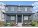 Charming two-story home with a welcoming front porch and beautifully landscaped front yard at 10610 Reunion Pkwy, Commerce City, CO 80022