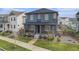 Well-maintained two-story home with a covered porch and landscaping at 10610 Reunion Pkwy, Commerce City, CO 80022