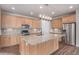 Spacious kitchen with a large island, stainless steel appliances, light wood cabinets, and modern backsplash at 10610 Reunion Pkwy, Commerce City, CO 80022