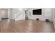 Spacious living room features hardwood floors and a staircase to the second floor at 10610 Reunion Pkwy, Commerce City, CO 80022