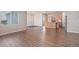 Open floorplan featuring hardwood floors, a kitchen with an island, and a large window at 10610 Reunion Pkwy, Commerce City, CO 80022