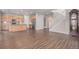 Spacious open-concept living space features hardwood floors, a kitchen, and staircase at 10610 Reunion Pkwy, Commerce City, CO 80022