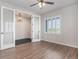 Bright room with a large window with shutter blinds, and a light fixture with glass french doors leading to another room at 10610 Reunion Pkwy, Commerce City, CO 80022