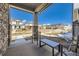 Relaxing front porch with outdoor seating, offering a view of the neighborhood's landscaping and well-maintained residences at 745 N Tempe St, Aurora, CO 80018