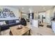 Open-concept living area with hardwood floors, seamlessly connects the living room, dining area, and modern kitchen at 745 N Tempe St, Aurora, CO 80018