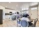 Bright open-concept layout integrates the dining area, kitchen with island seating, and a comfortable living space at 745 N Tempe St, Aurora, CO 80018
