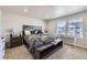 Cozy main bedroom features a bench at the foot of the bed and a window providing natural light at 745 N Tempe St, Aurora, CO 80018