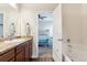 Charming bathroom boasts modern fixtures, wood-look floors, and access to the bedroom at 9533 Cherry Ln, Thornton, CO 80229