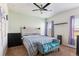 Comfortable bedroom featuring a ceiling fan, large window, and neutral tones at 9533 Cherry Ln, Thornton, CO 80229