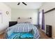 Bright bedroom with a ceiling fan, natural light, and stylish furnishings at 9533 Cherry Ln, Thornton, CO 80229
