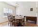 Dining room features hardwood floors, a modern light fixture, and a window at 9533 Cherry Ln, Thornton, CO 80229