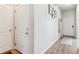 Bright hallway featuring wood-look floors and neutral wall paint at 9533 Cherry Ln, Thornton, CO 80229