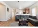 Inviting living room boasts wood floors, modern decor, and seamless flow to kitchen at 9533 Cherry Ln, Thornton, CO 80229