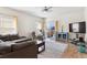 Living room with hardwood floors, a ceiling fan, and natural light at 9533 Cherry Ln, Thornton, CO 80229