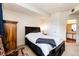 Bright bedroom with a plush carpet, and a view leading to an en-suite bathroom at 12820 Ironstone Way # 103, Parker, CO 80134