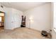 Carpeted bedroom with white walls, two doors and a window at 12820 Ironstone Way # 103, Parker, CO 80134