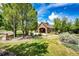 Attractive brick clubhouse, surrounded by green lawn, trees, and landscaping at 12820 Ironstone Way # 103, Parker, CO 80134