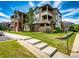 View of the exterior of the condo complex showing well-maintained lawns and garden areas at 12820 Ironstone Way # 103, Parker, CO 80134