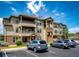 Multi-story condo complex featuring parking, manicured lawn, attractive architectural details and landscaping at 12820 Ironstone Way # 103, Parker, CO 80134