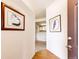 Bright hallway featuring hardwood floors, wall decor and leading to a modern kitchen at 12820 Ironstone Way # 103, Parker, CO 80134