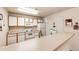 Bright kitchen with white appliances and a breakfast bar, perfect for casual dining at 12820 Ironstone Way # 103, Parker, CO 80134