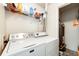 Functional laundry room with Maytag washer and dryer, and shelving for storage at 12820 Ironstone Way # 103, Parker, CO 80134
