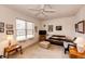 Cozy living room with a ceiling fan, comfortable seating, and natural light from the window at 12820 Ironstone Way # 103, Parker, CO 80134