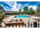 Resort-style pool surrounded by lounge chairs, mature trees, and lush landscaping for relaxation and recreation at 12820 Ironstone Way # 103, Parker, CO 80134