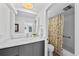 This bathroom offers a modern vanity and a shower with floral curtain at 2 Adams St # 806, Denver, CO 80206