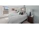 Bright bedroom featuring a comfortable bed, stylish decor, and natural light from a large window at 2 Adams St # 806, Denver, CO 80206