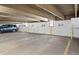 Well-lit underground parking garage with designated parking spaces and visible space numbers at 2 Adams St # 806, Denver, CO 80206