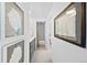 Bright hallway with lovely artwork leads to bathroom with a tub at 2 Adams St # 806, Denver, CO 80206