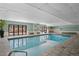 Well-maintained indoor pool area with tile surround, floor-to-ceiling windows, and ample natural light at 2 Adams St # 806, Denver, CO 80206