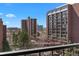 Balcony view of multiple buildings and mature trees at 2 Adams St # 806, Denver, CO 80206