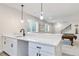 Basement bar with quartz counter, bar-height cabinets and drawers, pendant lights, and basement window at 1581 Diamond Hill Ct, Castle Rock, CO 80104