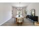 Stylish dining room featuring a wooden table with plush chairs and a chic black accent cabinet at 1581 Diamond Hill Ct, Castle Rock, CO 80104