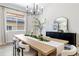 Contemporary dining room featuring a large wooden table, modern chandelier, and elegant décor at 1581 Diamond Hill Ct, Castle Rock, CO 80104