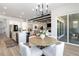 Open-concept dining area with modern chandelier, adjacent to the kitchen and living area at 1581 Diamond Hill Ct, Castle Rock, CO 80104