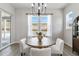 Dining room with elegant chandelier, large window, and sliding doors with a view of the backyard at 1581 Diamond Hill Ct, Castle Rock, CO 80104