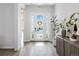 Bright foyer features beautiful hard wood floors, a decorative wreath, and access to the main living areas at 1581 Diamond Hill Ct, Castle Rock, CO 80104
