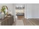 Inviting hallway with hardwood floors leading to a cozy living room and a stylishly decorated console table at 1581 Diamond Hill Ct, Castle Rock, CO 80104