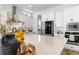 The bright kitchen features white countertops, cabinetry, stainless appliances, and a large island at 1581 Diamond Hill Ct, Castle Rock, CO 80104