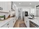 Modern kitchen featuring white cabinetry, sleek countertops, stainless appliances, and a designer backsplash at 1581 Diamond Hill Ct, Castle Rock, CO 80104