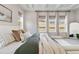 Light filled main bedroom featuring a comfortable bed, stylish decor and large windows at 1581 Diamond Hill Ct, Castle Rock, CO 80104