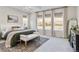 Serene main bedroom featuring large windows, a comfortable bed, and stylish decor to create a peaceful retreat at 1581 Diamond Hill Ct, Castle Rock, CO 80104